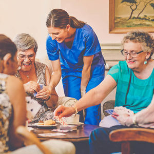 carer playing cards with the elderly